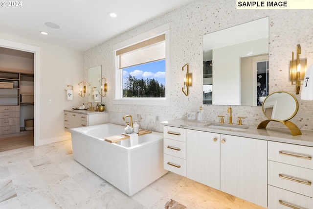 bathroom featuring two vanities, a sink, marble finish floor, a spacious closet, and tasteful backsplash