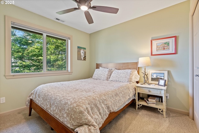 carpeted bedroom with ceiling fan, baseboards, and visible vents