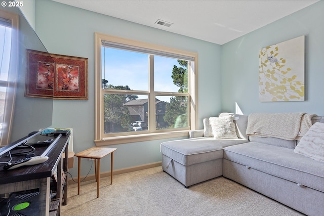 living room featuring carpet flooring, visible vents, and baseboards