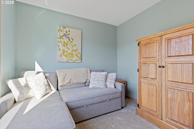 living area featuring carpet flooring and baseboards