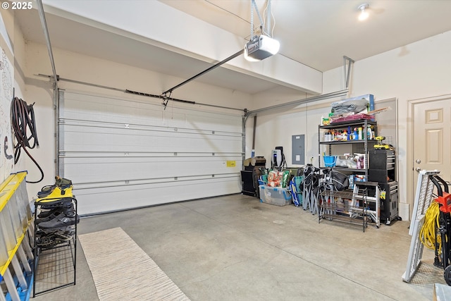 garage with a garage door opener and electric panel
