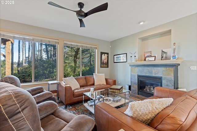 living area with a fireplace and ceiling fan