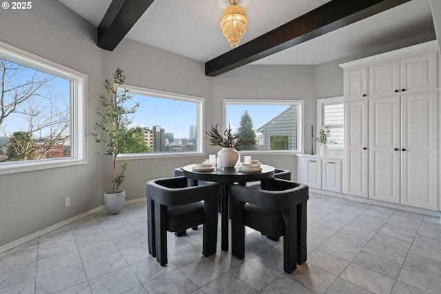 dining room with beam ceiling, marble finish floor, a view of city, and baseboards