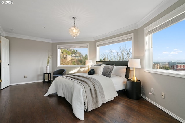 bedroom featuring multiple windows, ornamental molding, and wood finished floors