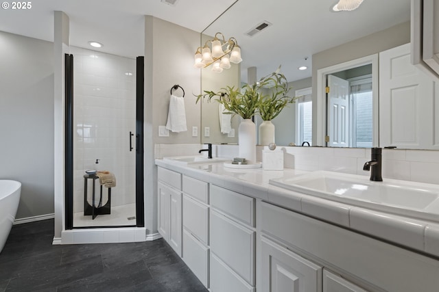 bathroom featuring a sink, visible vents, a stall shower, and double vanity