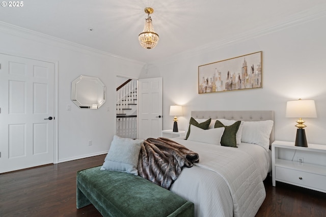 bedroom with a chandelier, crown molding, and wood finished floors