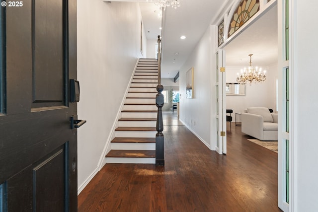 foyer with recessed lighting, stairway, an inviting chandelier, baseboards, and dark wood-style flooring