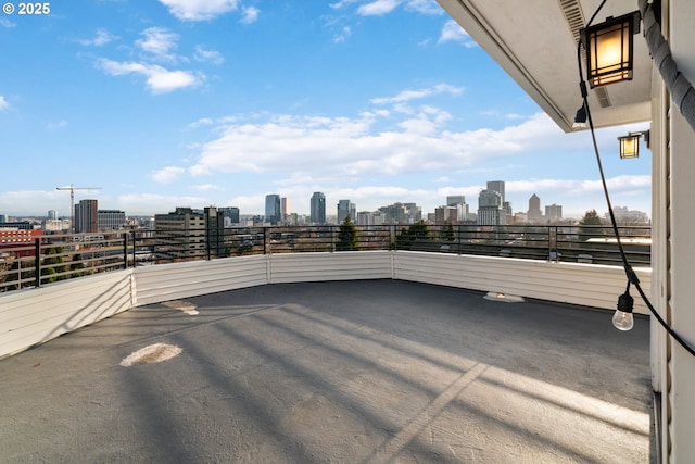 view of patio / terrace featuring a view of city and a balcony