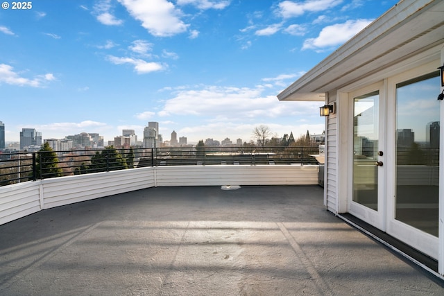 view of patio / terrace with a balcony and a view of city