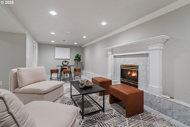 living room with a high end fireplace, recessed lighting, baseboards, and ornamental molding