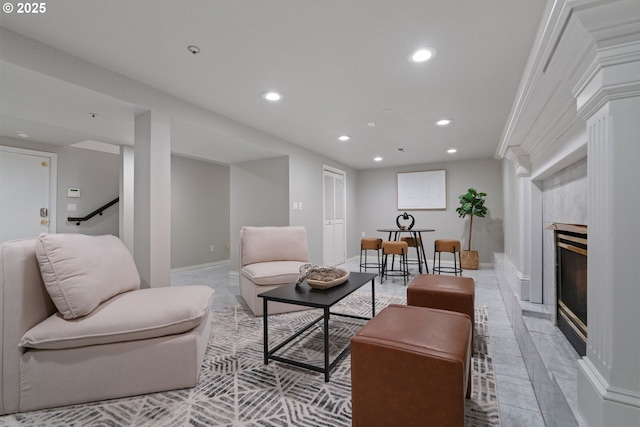 living room featuring recessed lighting, a fireplace, and baseboards