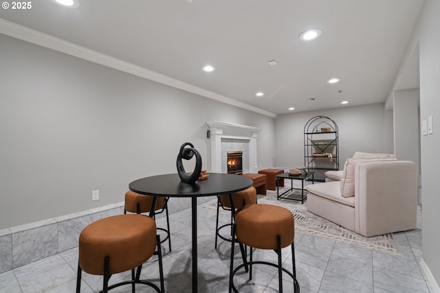 dining room featuring ornamental molding, recessed lighting, marble finish floor, and a tile fireplace