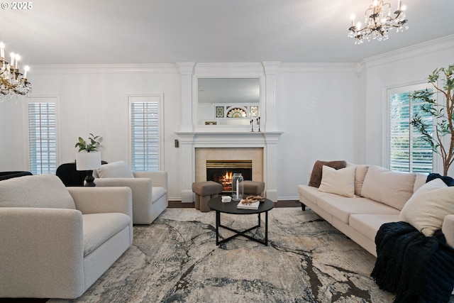 living room with a notable chandelier, a fireplace, wood finished floors, and ornamental molding