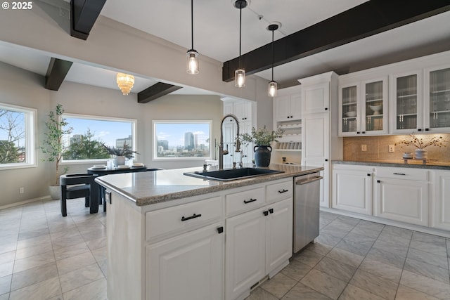 kitchen featuring dishwasher, decorative backsplash, beam ceiling, and a sink