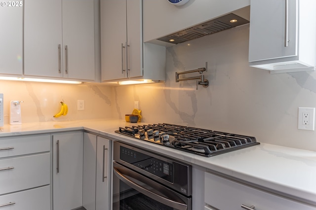 kitchen with stainless steel oven, gas cooktop, tasteful backsplash, custom range hood, and white cabinets