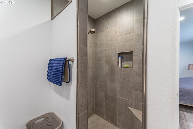 full bath with a tile shower
