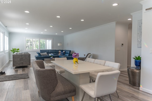 dining room featuring baseboards, recessed lighting, light wood-style flooring, and ornamental molding