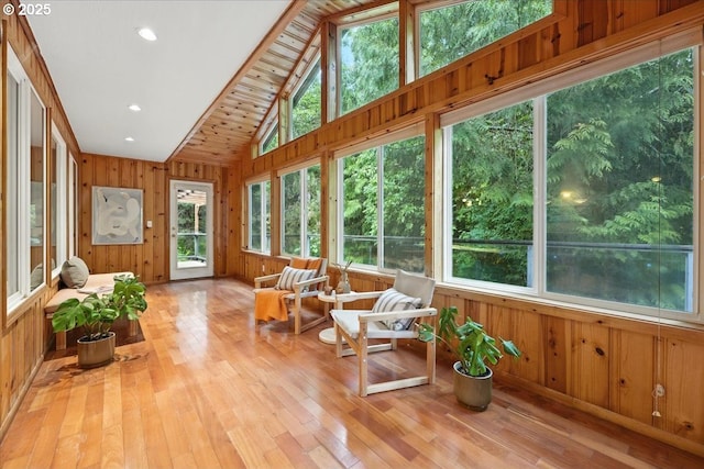 80487 Sha Ne Mah Rd, Seaside, OR 97138 - sunroom / solarium featuring healthy amount of natural light, wooden walls, hardwood / wood-style flooring, high vaulted ceiling, and a wooden deck