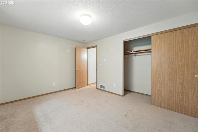 80487 Sha Ne Mah Rd, Seaside, OR 97138 - unfurnished bedroom featuring light colored carpet, a closet, and a textured ceiling