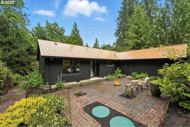 80487 Sha Ne Mah Rd, Seaside, OR 97138 - rear view of house with an outdoor fire pit, a patio, a metal roof, and crawl space