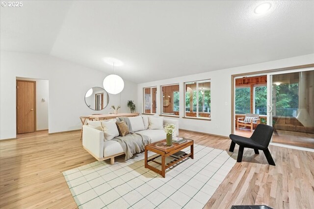 80487 Sha Ne Mah Rd, Seaside, OR 97138 - living area featuring vaulted ceiling and light wood-style floors