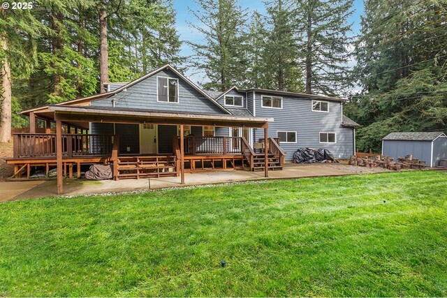 back of property with a yard, a shed, a patio, and an outdoor structure