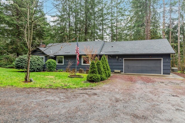 ranch-style home with dirt driveway, a front yard, and an attached garage
