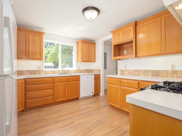 3511 SW Coronado St, Portland, OR 97219 - kitchen with white appliances, light wood-style floors, light countertops, and open shelves
