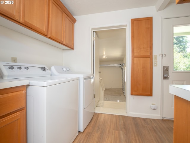 3511 SW Coronado St, Portland, OR 97219 - laundry area featuring light wood finished floors, cabinet space, and independent washer and dryer