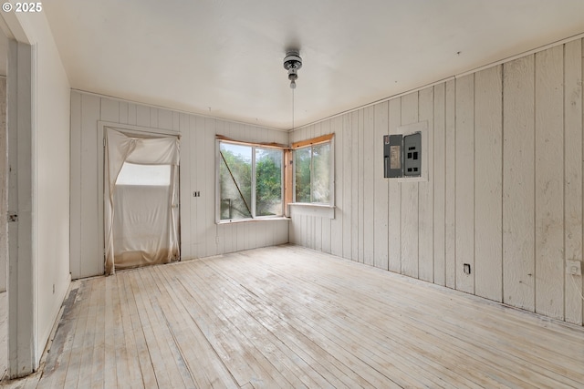 206 NE Laurel Ave, Myrtle Creek, OR 97457 - empty room with hardwood / wood-style flooring, wooden walls, and electric panel