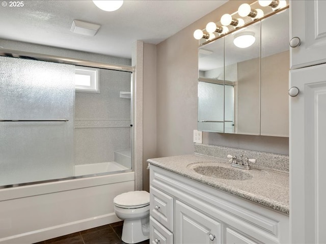 full bath with toilet, tile patterned floors, shower / bath combination with glass door, and vanity