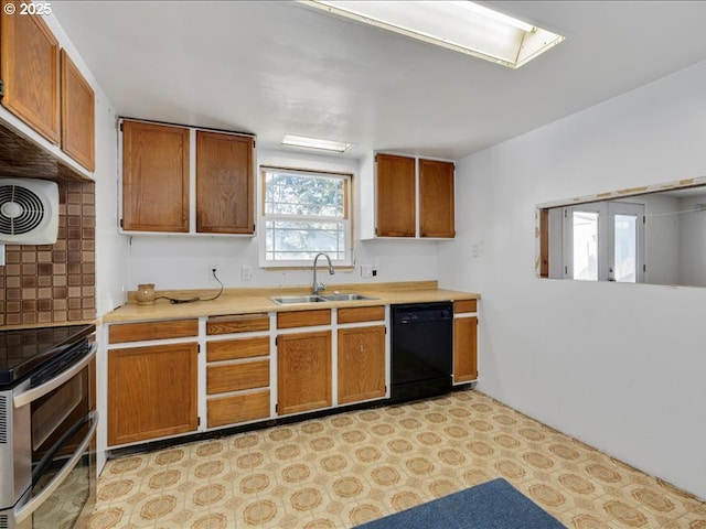 kitchen with brown cabinets, a sink, dishwasher, light countertops, and range with two ovens