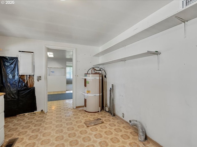 clothes washing area with laundry area, visible vents, water heater, and light floors