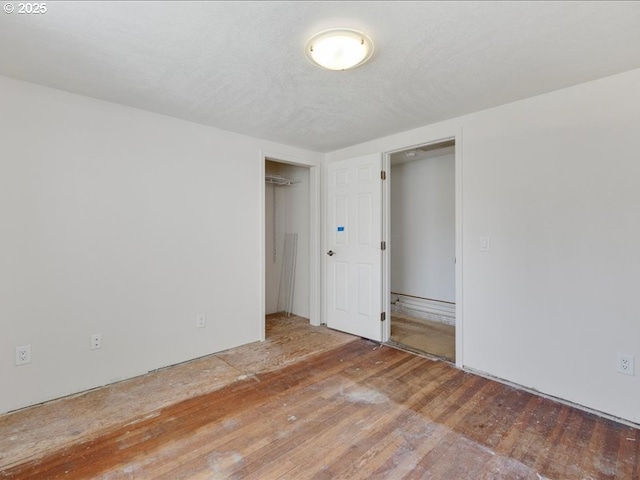 spare room featuring wood-type flooring