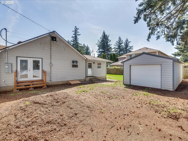 back of house featuring french doors, an outdoor structure, entry steps, and a garage
