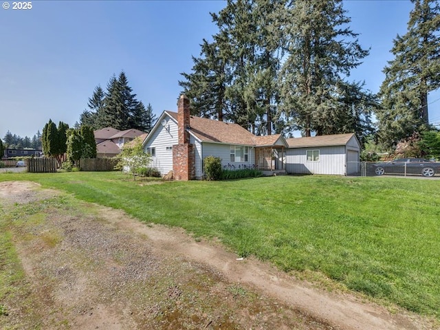 exterior space with fence, a yard, and a chimney