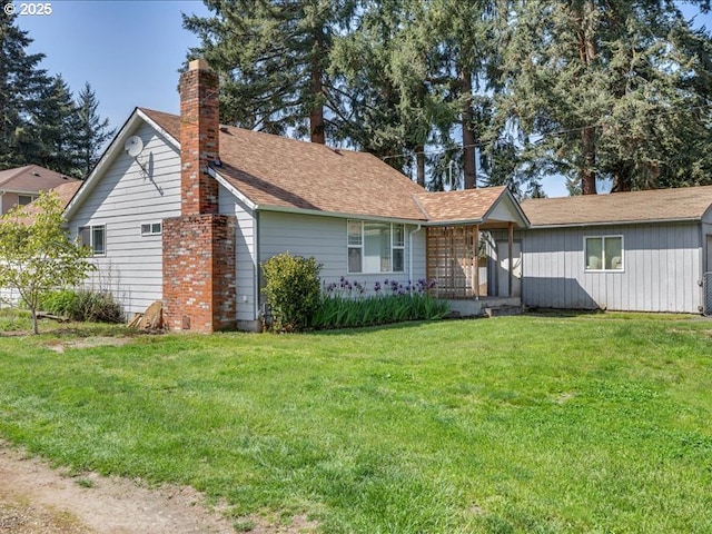 view of front facade featuring a chimney and a front lawn