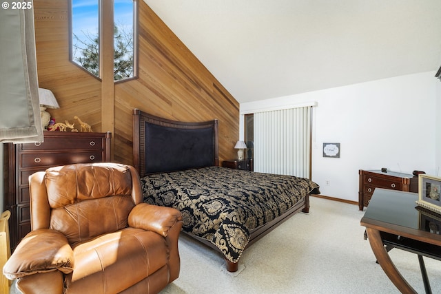 carpeted bedroom with vaulted ceiling, wood walls, and baseboards