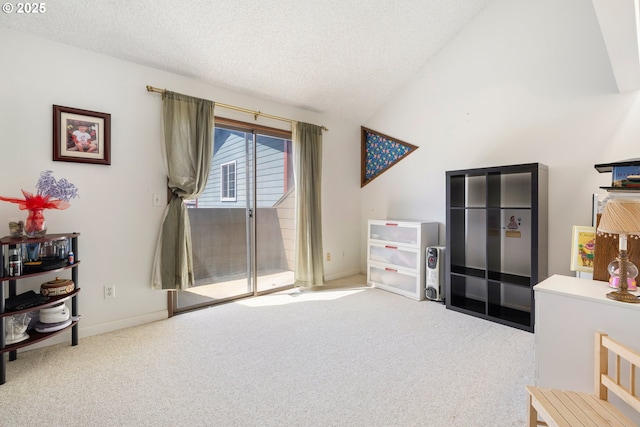 carpeted bedroom with access to exterior, vaulted ceiling, a textured ceiling, and baseboards