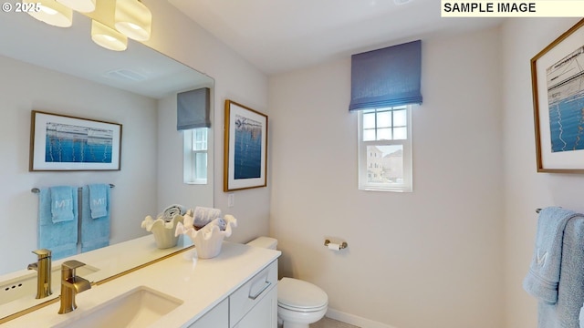 bathroom featuring vanity and toilet