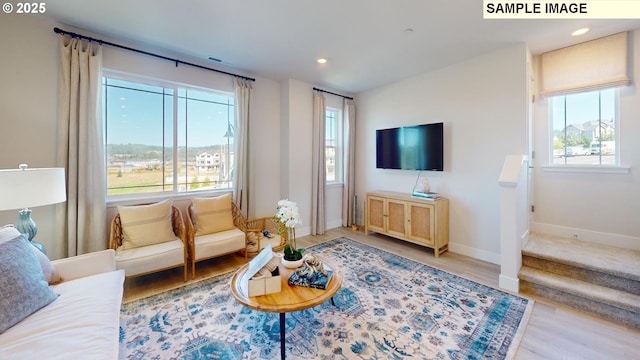 living room with plenty of natural light and light wood-type flooring