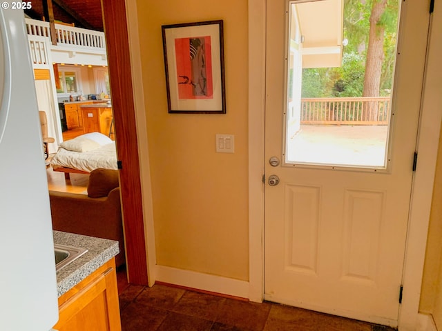 entryway featuring dark tile patterned flooring