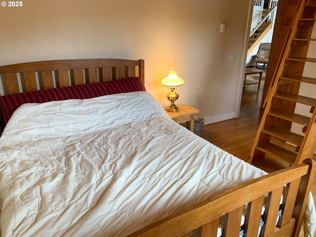 bedroom with hardwood / wood-style flooring