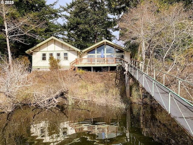 back of house with a deck with water view