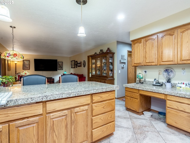 kitchen with decorative light fixtures and light tile patterned flooring