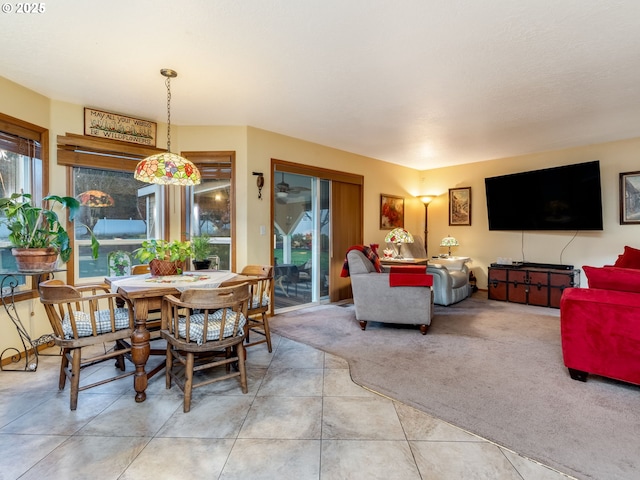 carpeted dining room featuring a healthy amount of sunlight