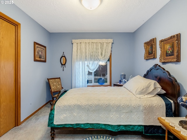 bedroom with carpet floors and a textured ceiling