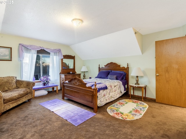 carpeted bedroom with a textured ceiling and vaulted ceiling