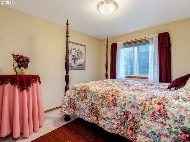 carpeted bedroom featuring a textured ceiling