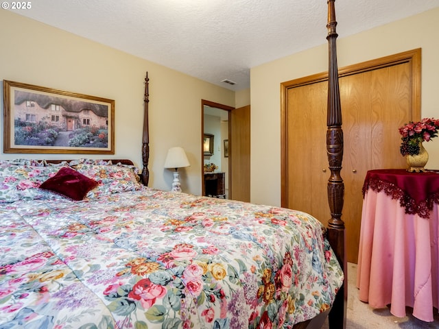 bedroom with a textured ceiling, a closet, and carpet floors